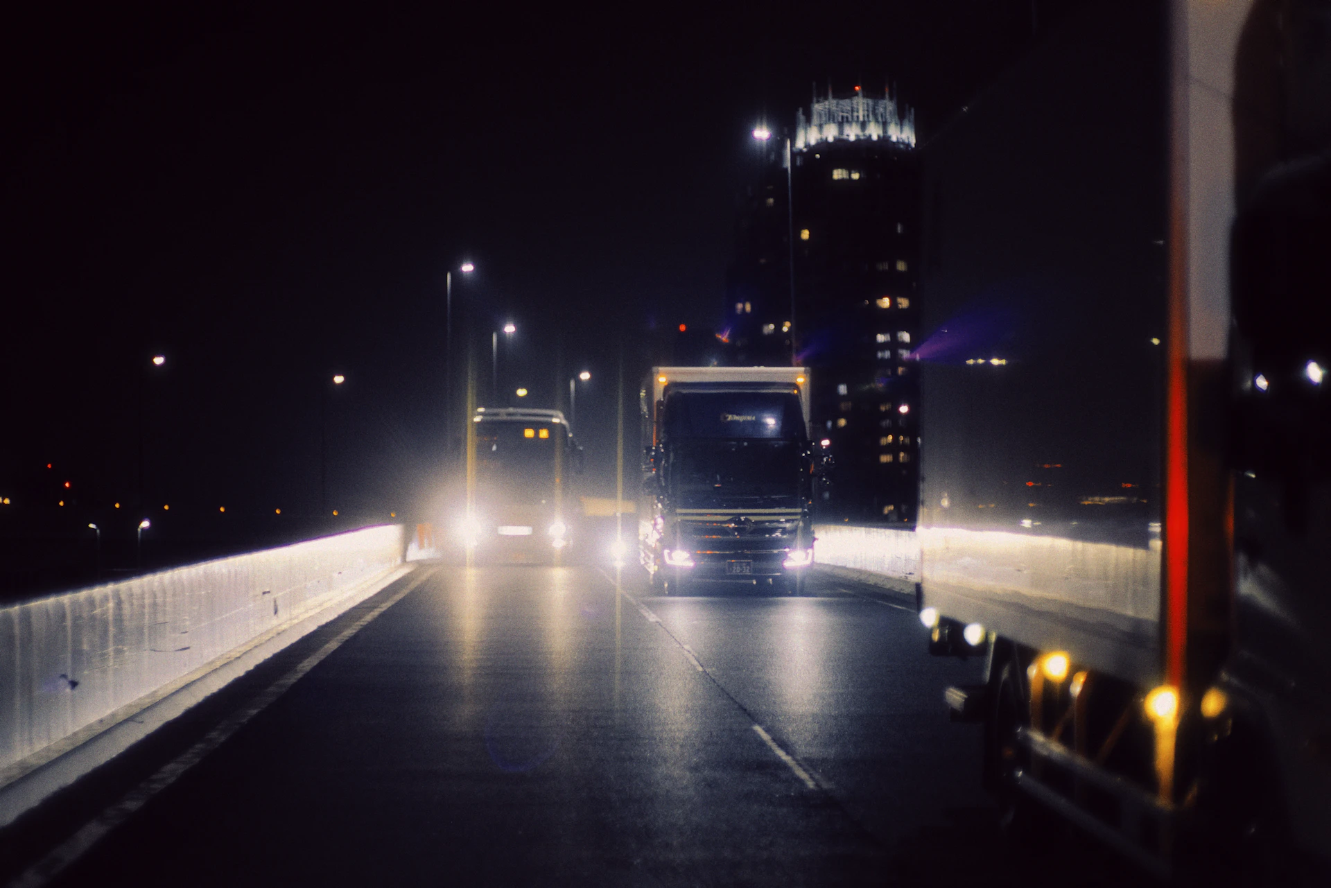 Truck driving down the highway at night