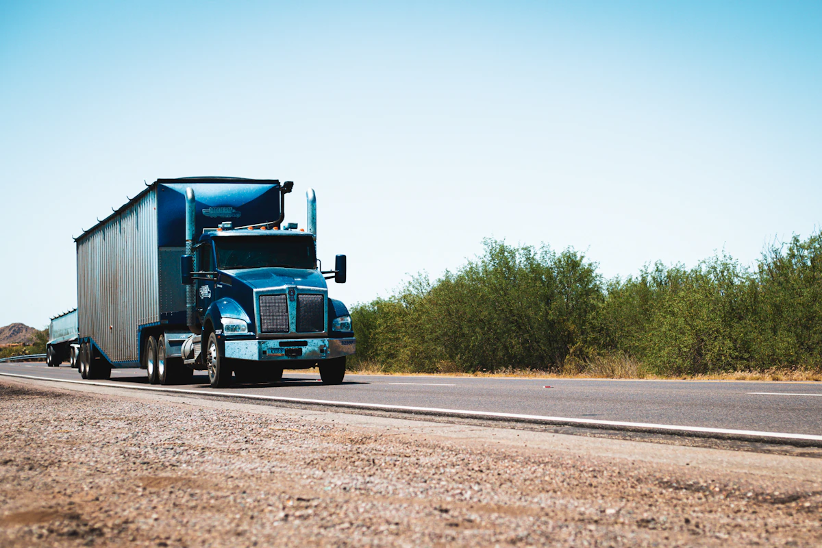 Semi-truck driving down a desert highway