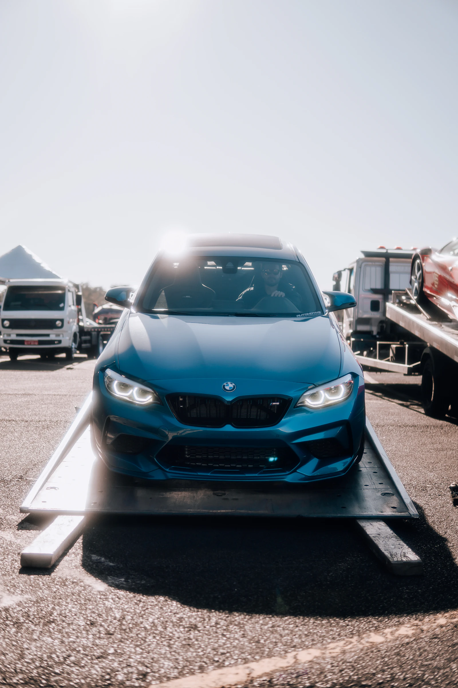 Modern sports car being loaded onto a flatbed tow truck